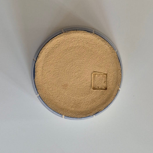 Base of the small pot on a light gray background