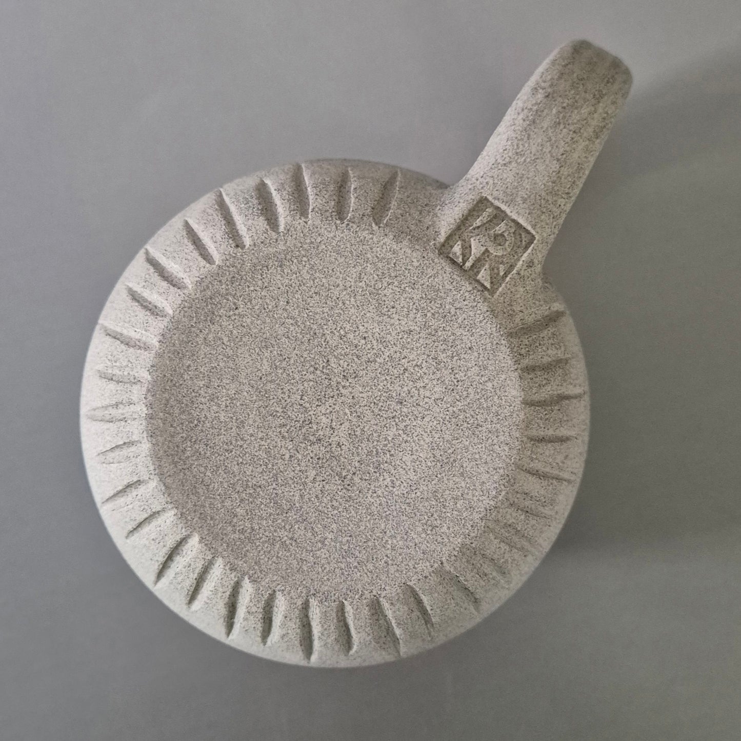 Base of Gray ceramic mug with handle on a gray background