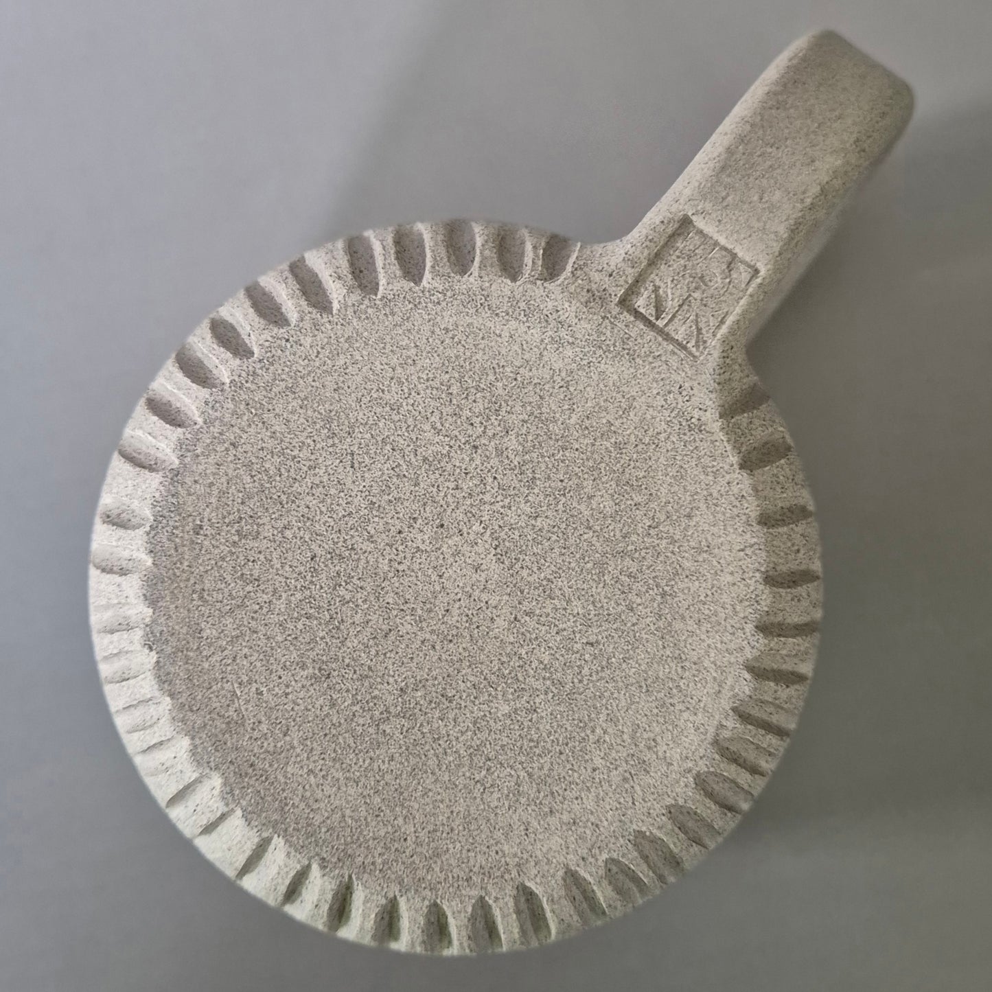 Base of ceramic mug on a gray background