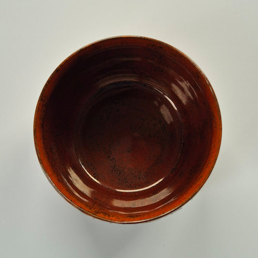 Brown ceramic pot on a light gray background
