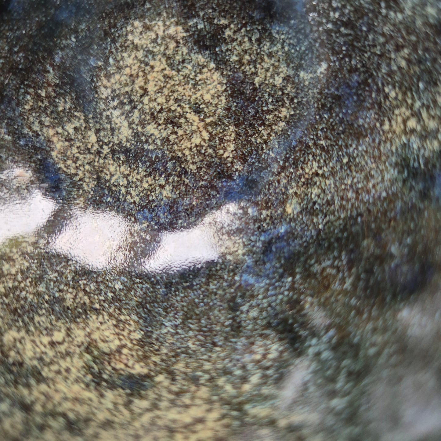 Close-up of the glazed surface with variations in color.