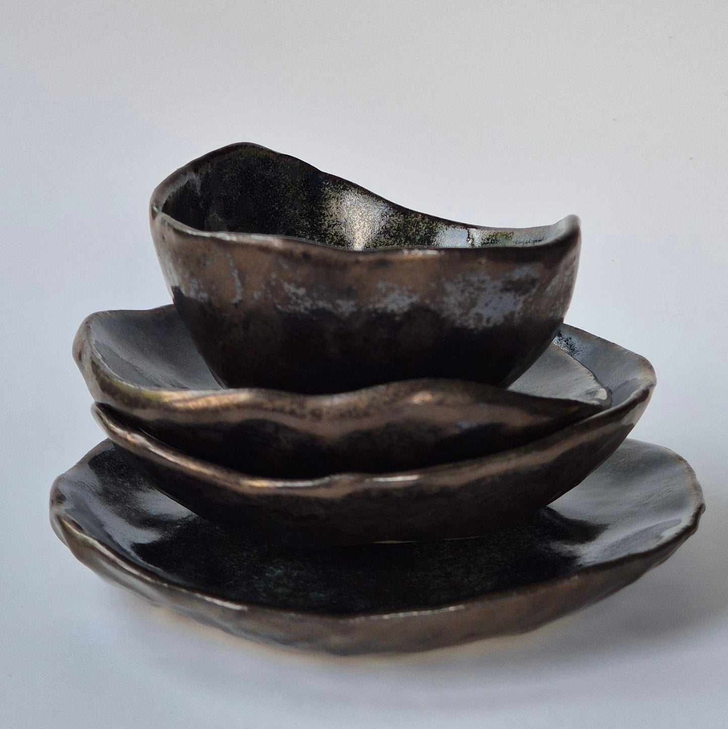 Set of black ceramic bowls on a light gray background