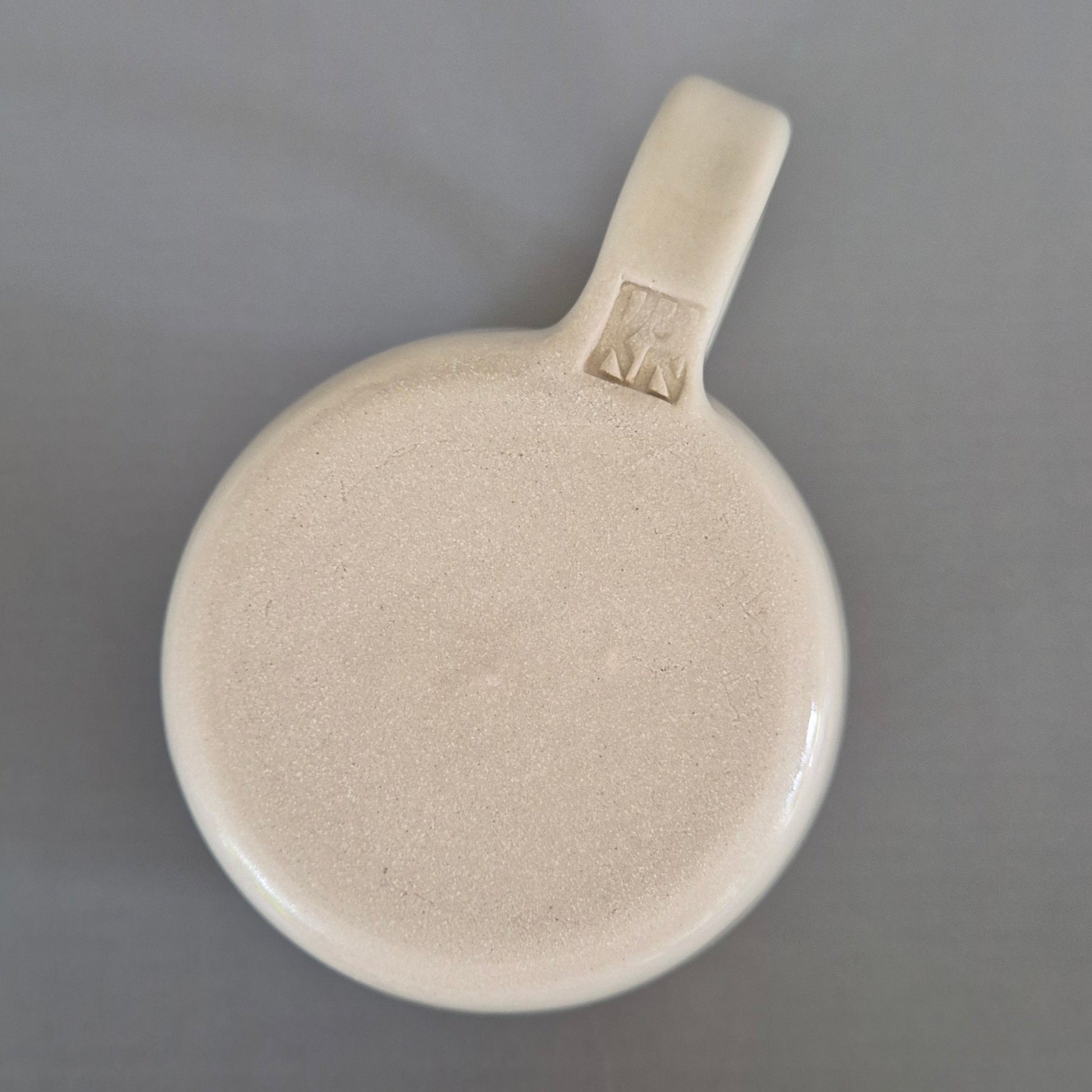 Beige ceramic mug on a gray background