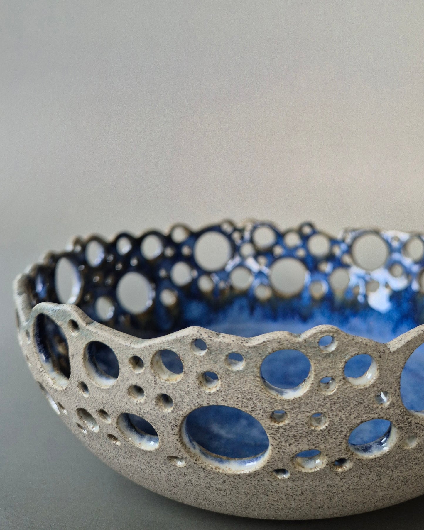 Ceramic bowl with blue and white bubble pattern on a gray background
