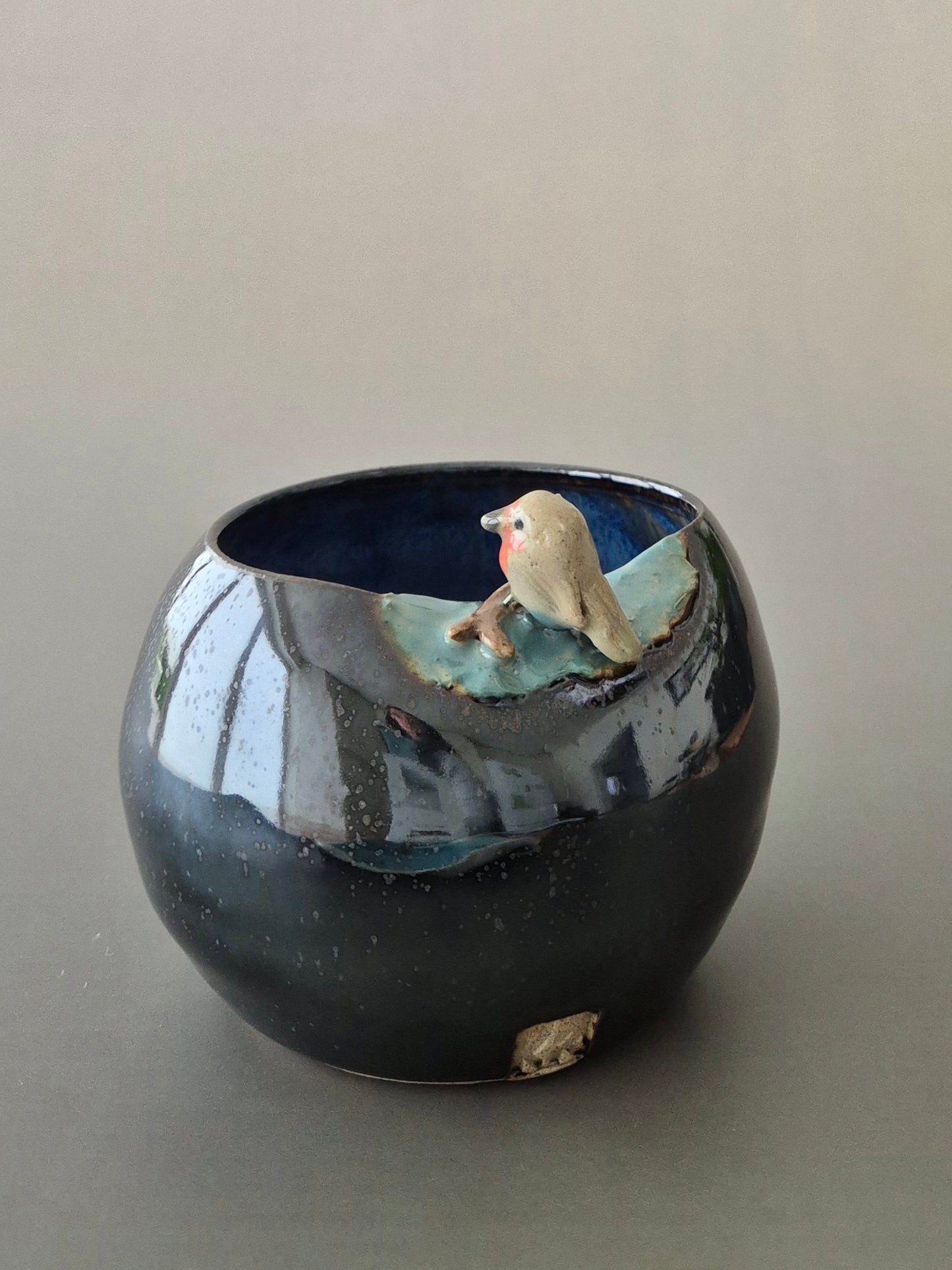 Ceramic bowl with a bird design on a plain background