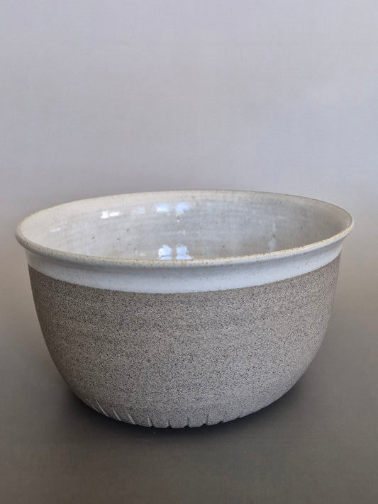 Speckled gray ceramic bowl on a plain background