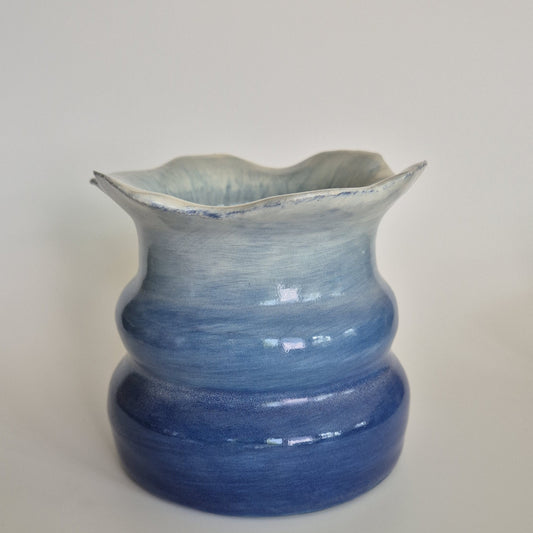 Blue ceramic pot on a grey background