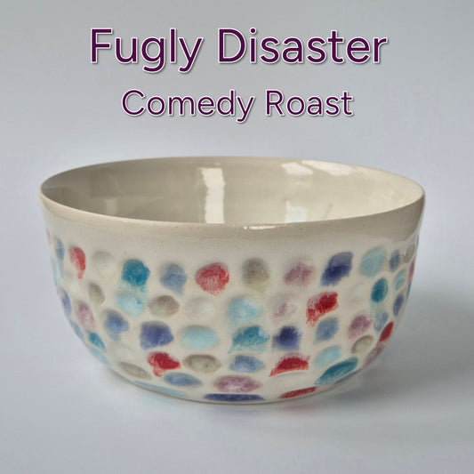 Ceramic bowl with colorful dot pattern on a white background, labeled 'Fugly Disaster Comedy Roast'.