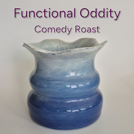 Blue ceramic pot on a grey background with text 'Functional Oddity Comedy Roast'.