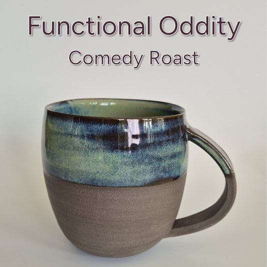 Anthracite brown stoneware mug with green flowy glaze and the words Fuctional Oddity Comedy Roast. On a plain background