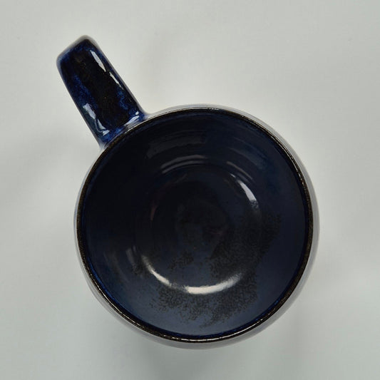 Blue ceramic mug on a light gray background