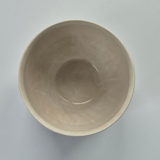 Inside of beige ceramic pot on a light gray background