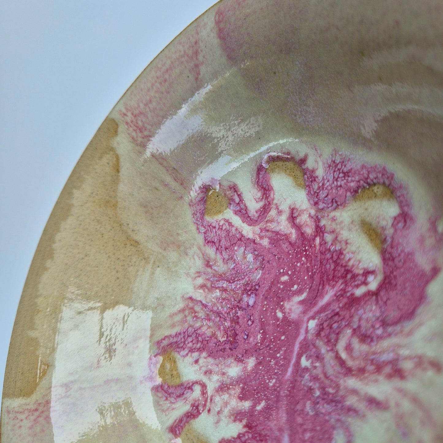 Close-up of a marbled surface with pink, white, and gold colors.