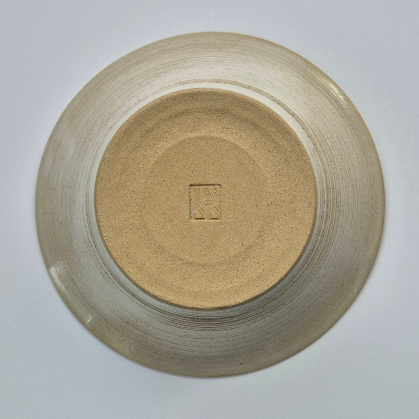 Base of ceramic bowl on a light gray background