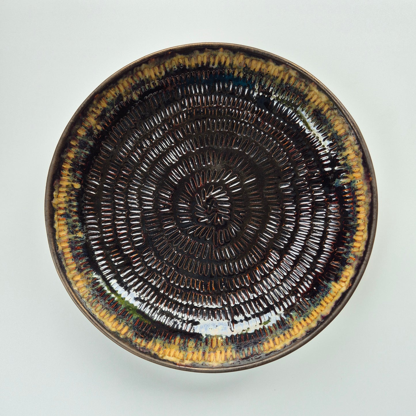 Ceramic plate with concentric circle pattern on a white background
