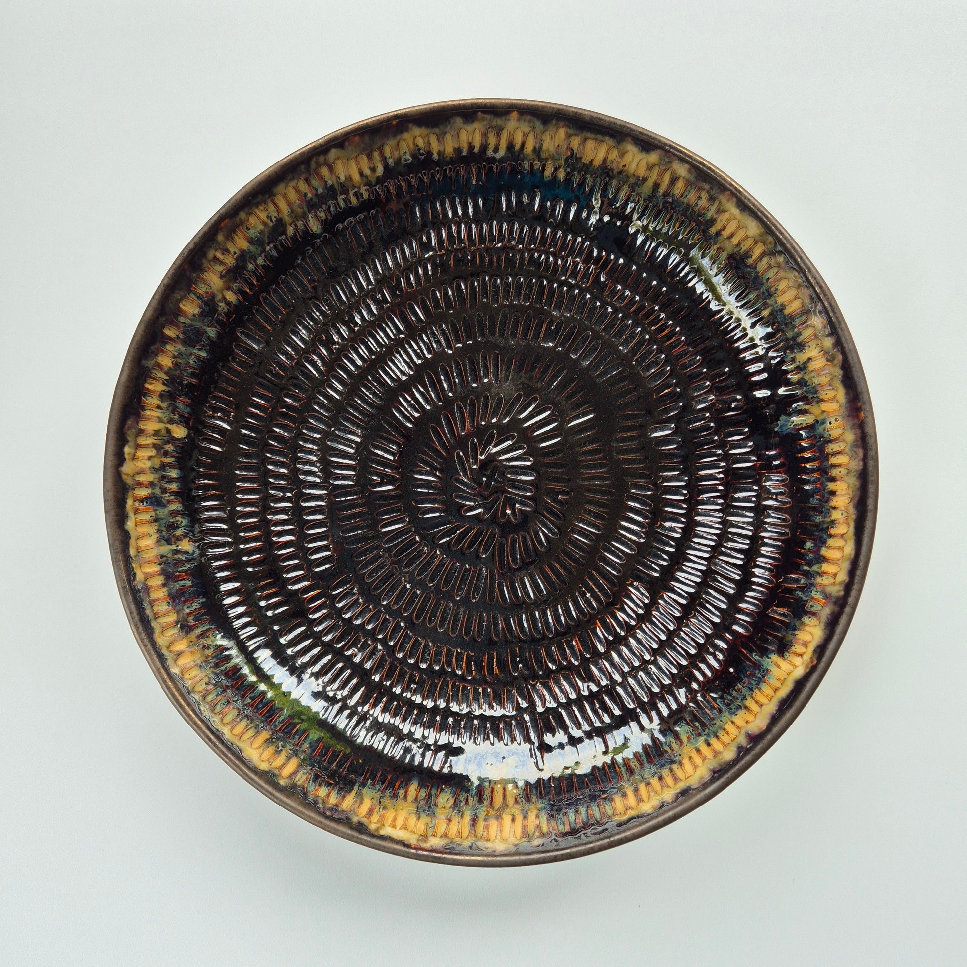Ceramic plate with concentric circle pattern on a white background