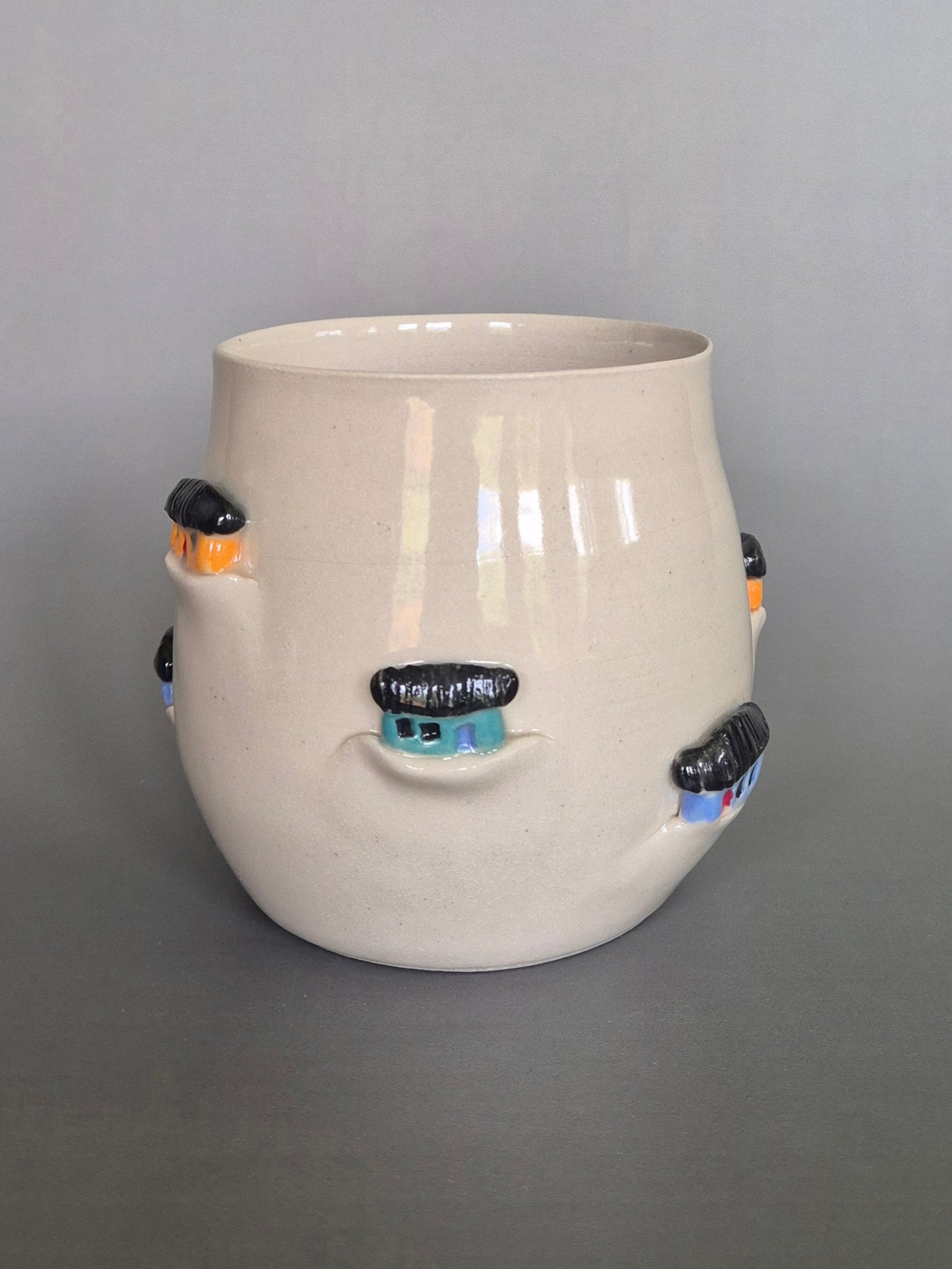 Ceramic vase with decorative elements on a gray background