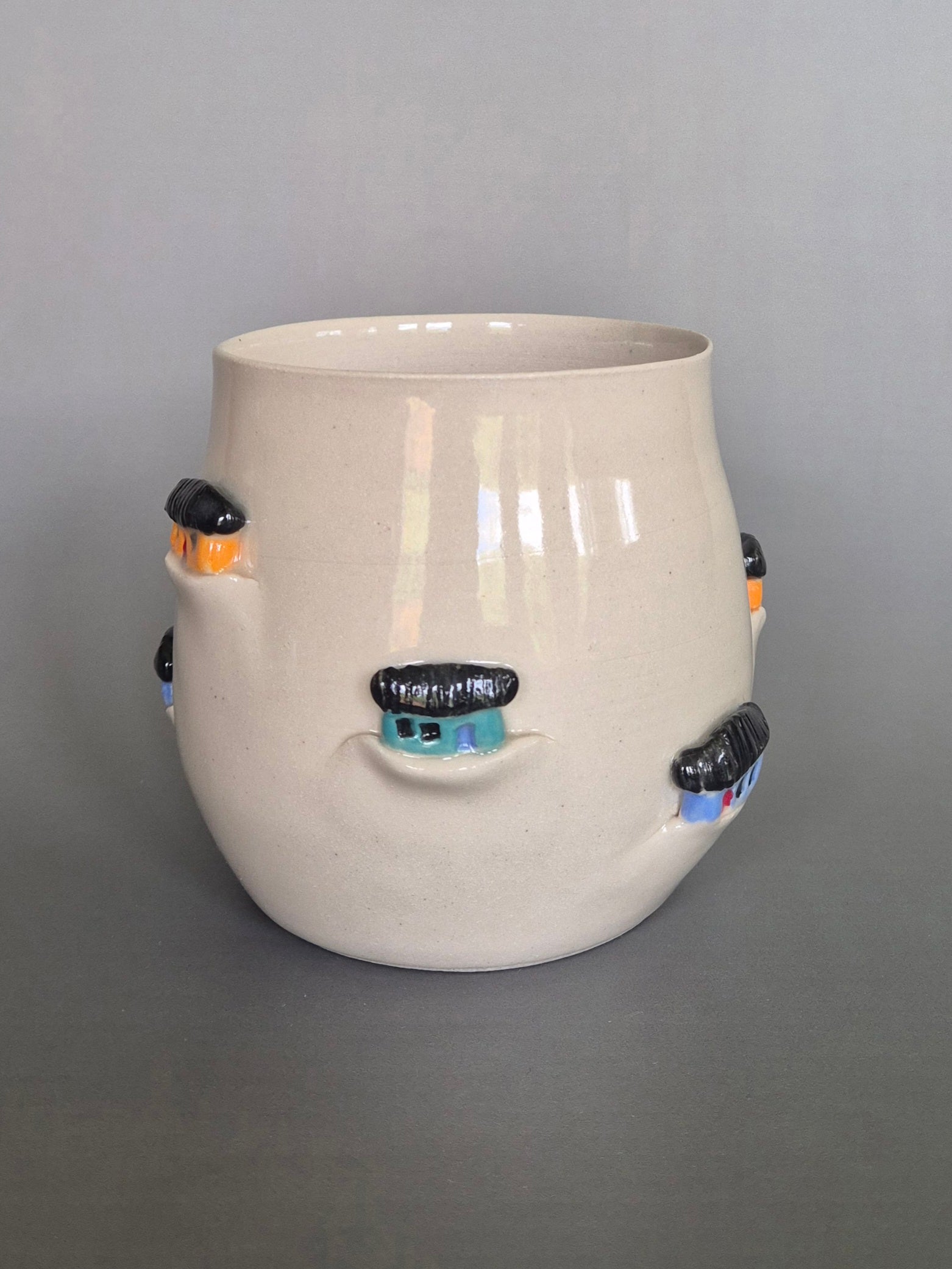 Ceramic vase with decorative elements on a gray background
