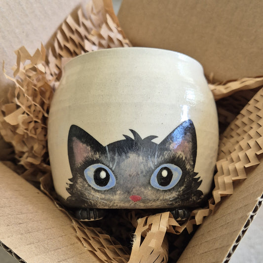 Hand-painted Cat Mug - Archie - face up in a cardboard box